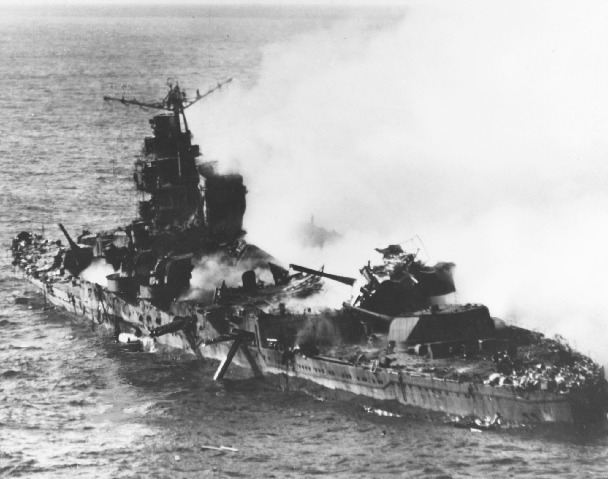 Japanese heavy cruiser Mikuma burning and listing after being hit by 6 bombs and having her torpedoes explode. June 6th, 1942 